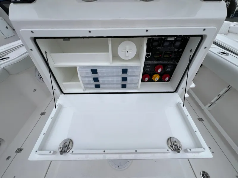 Slide: The Image of 2025 Sea Fox 288 Commander storage compartment with organized shelves and control panel. - 15