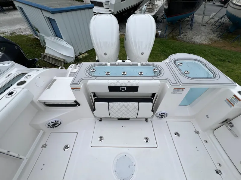Slide: The Image of 2025 Sea Fox 288 Commander boat deck with seating and storage compartments. - 16