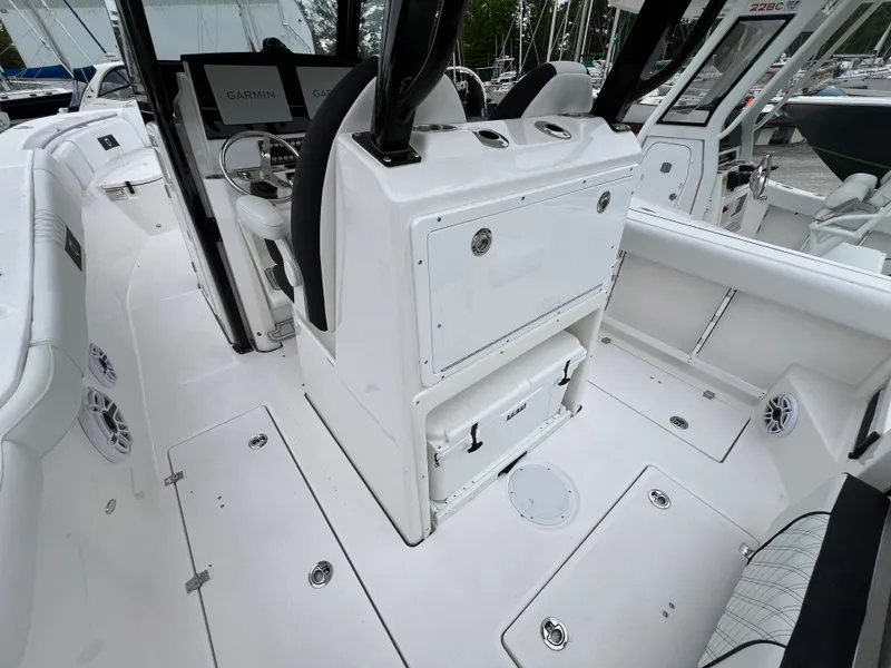 Slide: The Image of 2025 Sea Fox 288 Commander boat interior with white seating and Garmin navigation system. - 14