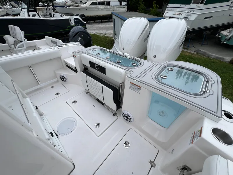 Slide: The Image of 2025 Sea Fox 288 Commander boat deck with dual engines and storage compartments. - 17