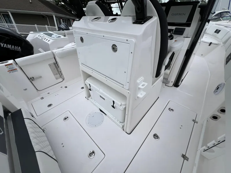 Slide: The Image of 2025 Sea Fox 288 Commander boat interior with storage compartments and Garmin equipment. - 13