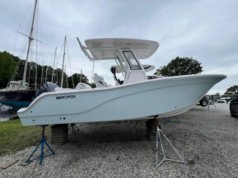 Slide: The Image of 2025 Sea Fox 228 Commander boat on stands, displayed outdoors. - 1