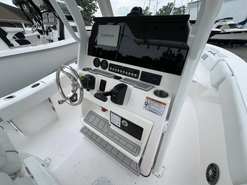 Slide: The Image of 2025 Sea Fox 228 Commander boat console with Garmin navigation system and steering wheel. - 3