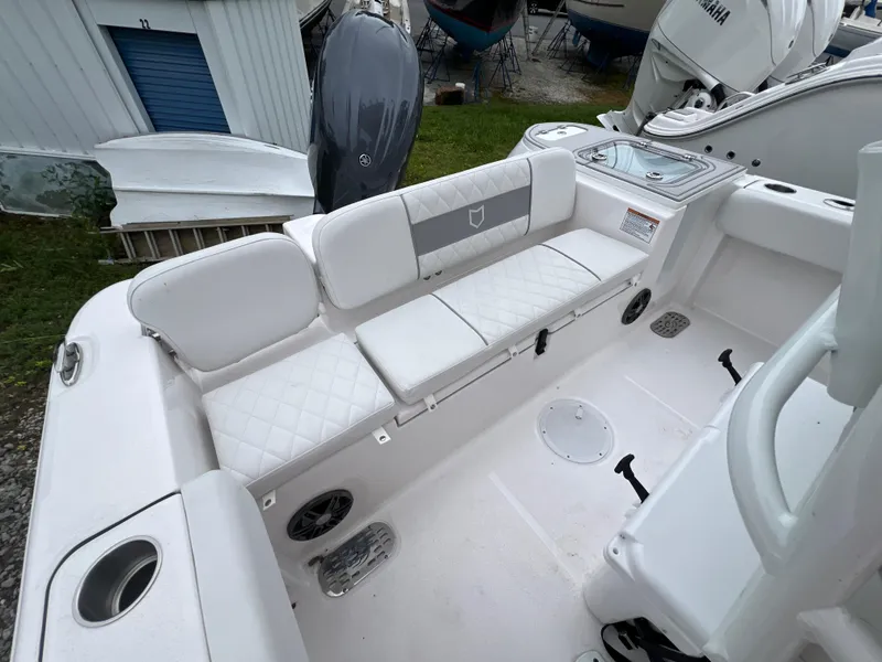 Slide: The Image of 2025 Sea Fox 228 Commander boat interior with white seating and storage compartments. - 6
