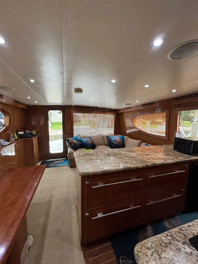 Slide: The Image of Interior of 2006 Hatteras 54 Convertible yacht with modern kitchen and cozy seating area. - 10