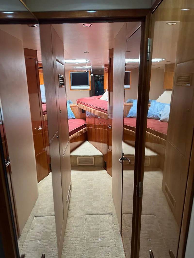 Slide: The Image of Interior of 2006 Hatteras 54 Convertible yacht, featuring cozy cabin with wood finishes. - 12
