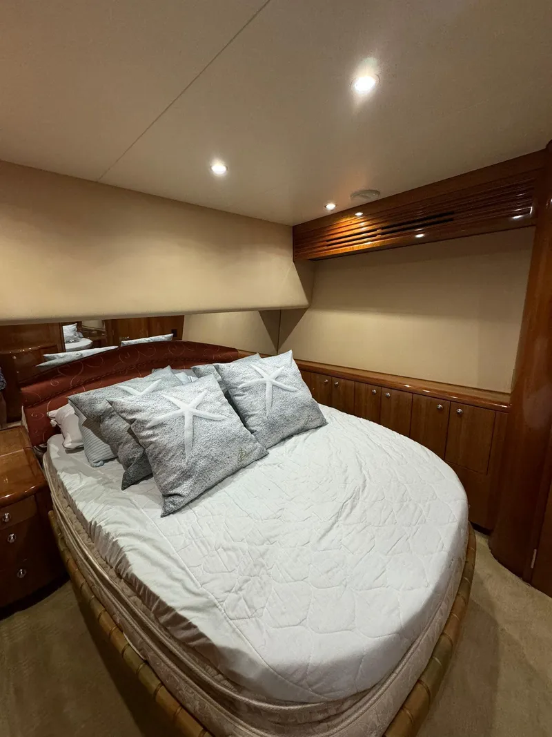 Slide: The Image of Luxurious bedroom in 2006 Hatteras 54 Convertible yacht with elegant wood cabinetry. - 14