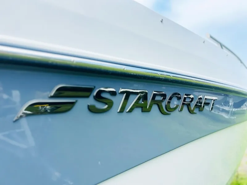 Slide: The Image of 2024 Starcraft SVX 231 OB DH boat logo on sleek hull. - 2