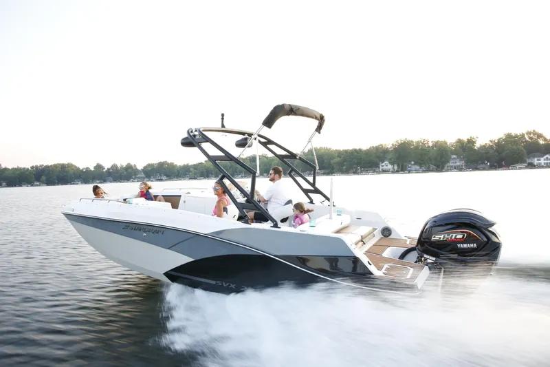 Slide: The Image of 2024 Starcraft SVX 231 OB DH boat cruising on a lake with passengers enjoying the ride. - 3