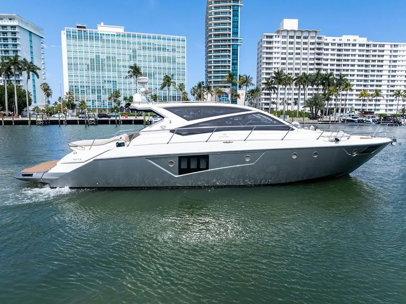 The Image of 2014 Cranchi 56 HT yacht cruising in urban waterfront setting. - 0