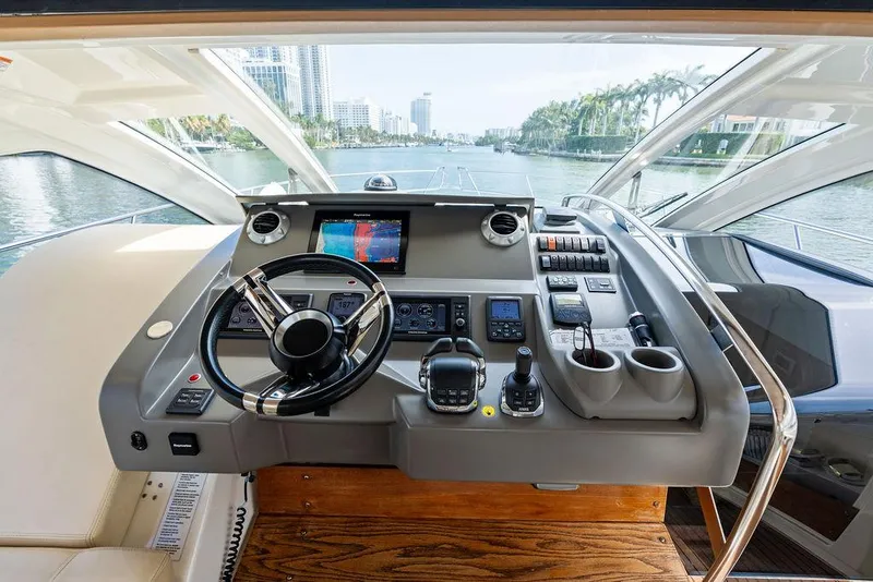 Slide: The Image of Helm of 2014 Cranchi 56 HT yacht with modern navigation equipment and waterfront view. - 38