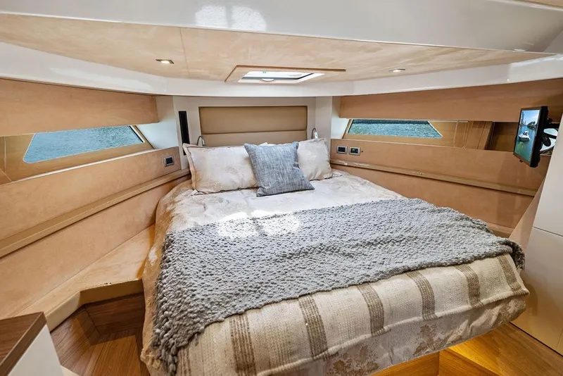 Slide: The Image of Luxurious bedroom interior of 2014 Cranchi 56 HT yacht with cozy bedding and natural light. - 49