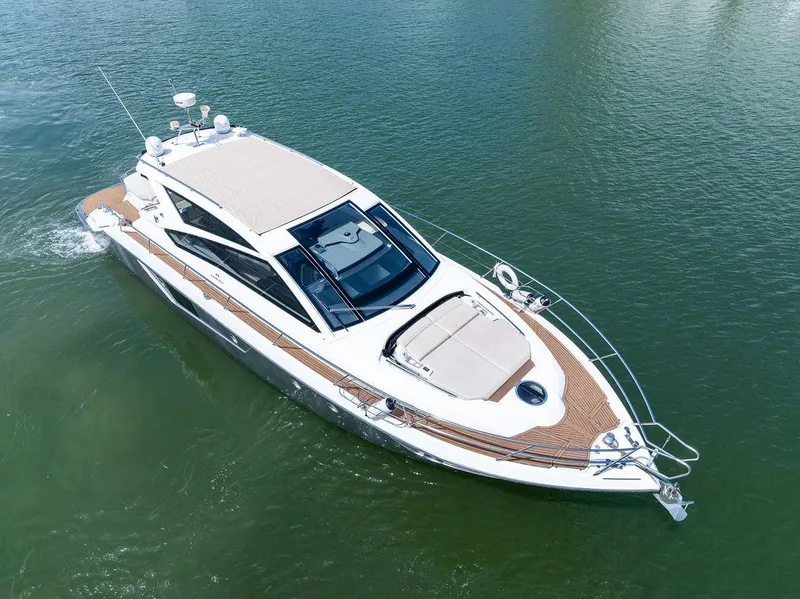 Slide: The Image of 2014 Cranchi 56 HT yacht cruising on calm waters, showcasing sleek design and luxury features. - 6