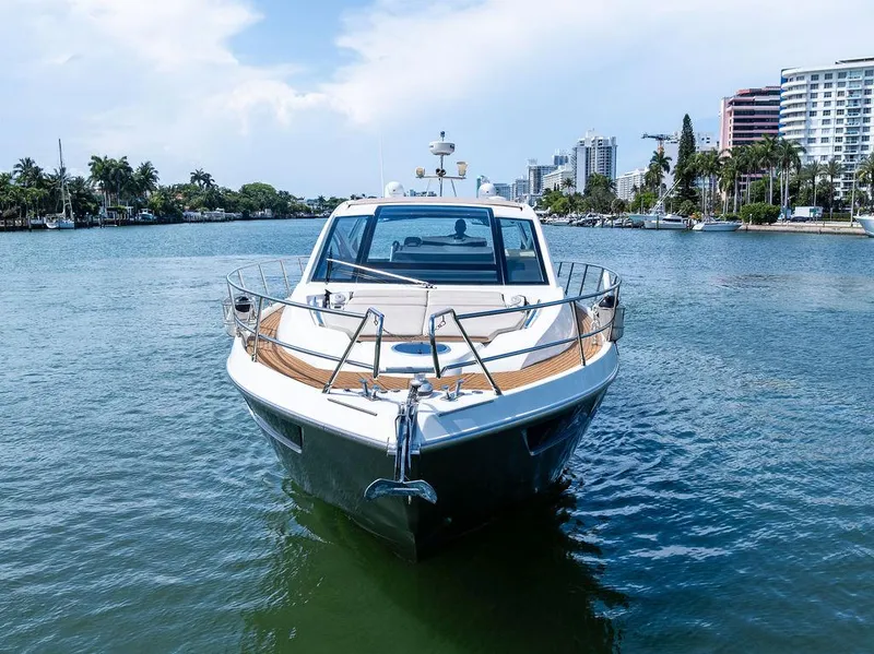 Slide: The Image of 2014 Cranchi 56 HT yacht on a scenic waterway with city skyline. - 7