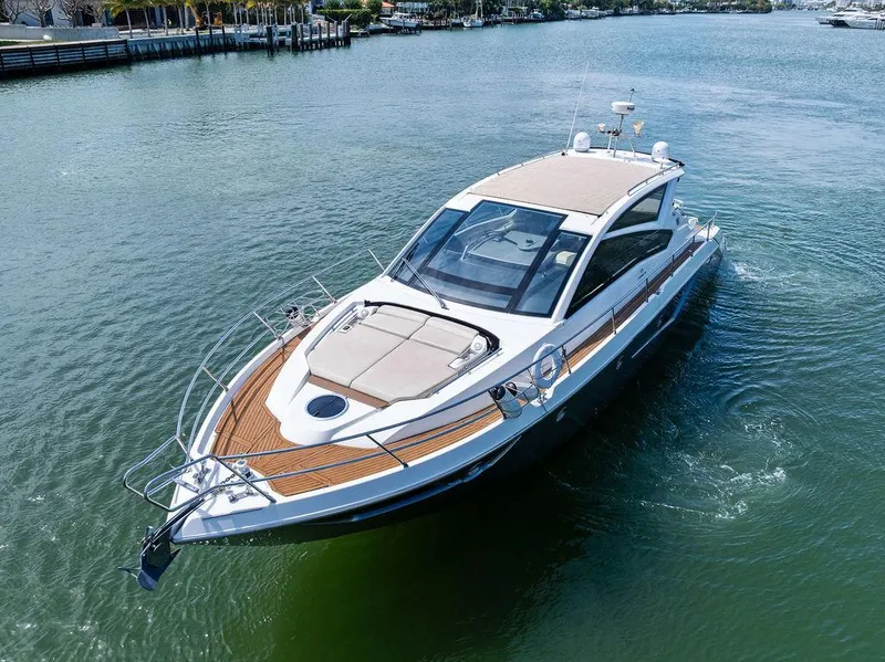 Slide: The Image of 2014 Cranchi 56 HT yacht cruising on calm waters, showcasing sleek design and luxury features. - 8