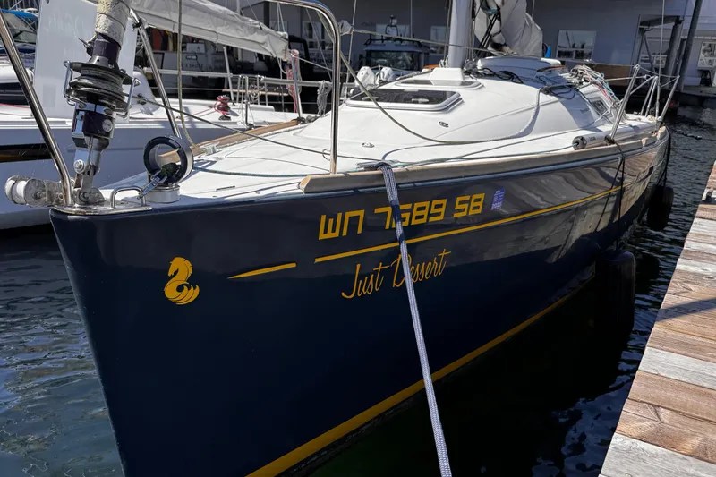 Slide: The Image of 2014 Beneteau FIRST 25 S sailboat docked, displaying registration and name "Just Dessert." - 1