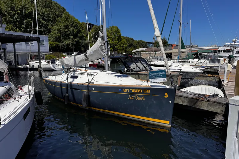 Slide: The Image of 2014 Beneteau FIRST 25 S sailboat docked at marina, surrounded by other boats. - 12