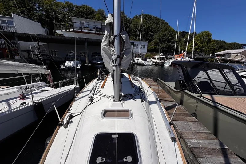 Slide: The Image of 2014 Beneteau FIRST 25 S sailboat docked at marina, surrounded by other boats. - 13