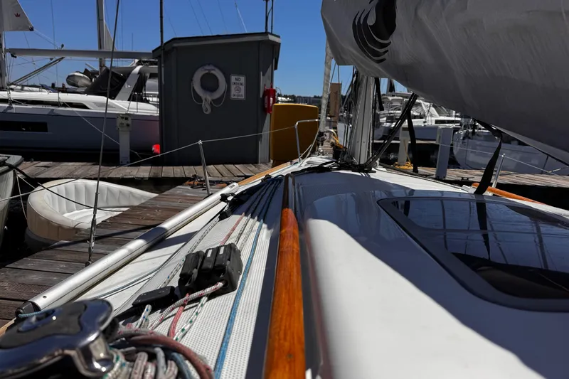 Slide: The Image of 2014 Beneteau FIRST 25 S sailboat docked at marina, showcasing deck and rigging details. - 16