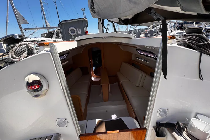 Slide: The Image of Interior view of 2014 Beneteau FIRST 25 S sailboat, showcasing cabin seating and nautical equipment. - 17