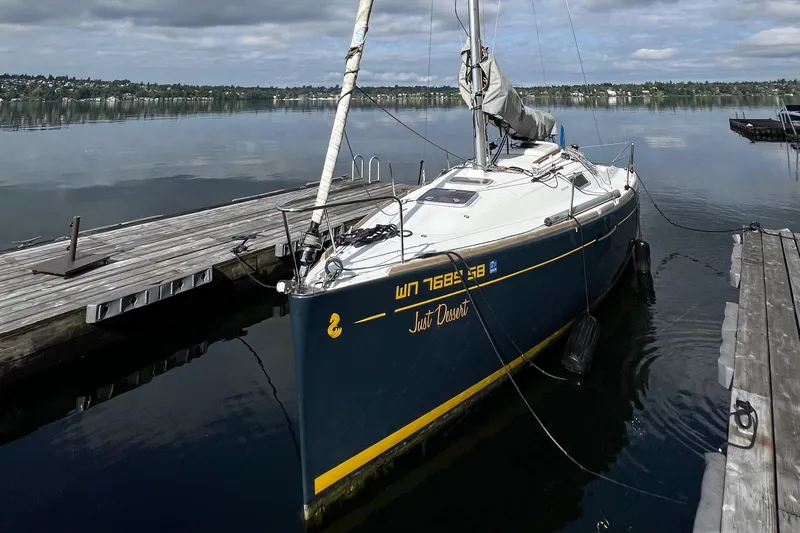 Slide: The Image of 2014 Beneteau FIRST 25 S sailboat docked on calm water. - 2