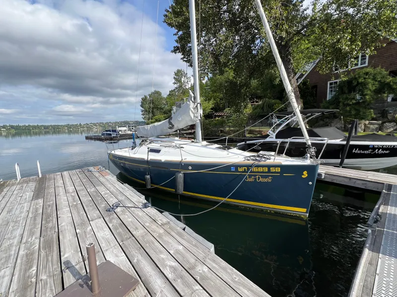 Slide: The Image of 2014 Beneteau FIRST 25 S sailboat docked by a wooden pier on a calm lake. - 3