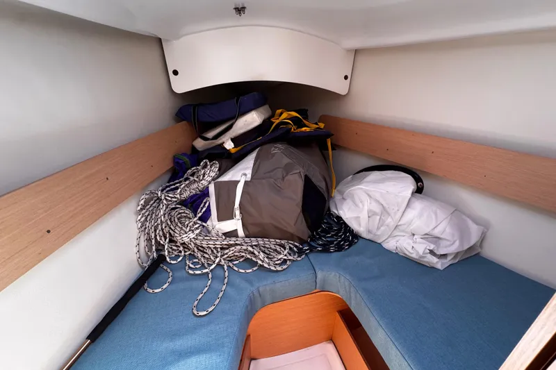 Slide: The Image of Cozy cabin interior of 2014 Beneteau FIRST 25 S sailboat with ropes and gear. - 31
