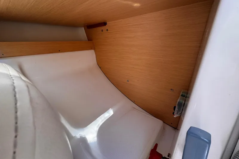Slide: The Image of Interior view of a 2014 Beneteau FIRST 25 S sailboat, featuring wood paneling and seating. - 33