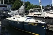 Slide: The Image of 2014 Beneteau FIRST 25 S sailboat docked at marina, surrounded by other boats. - 6