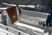 Slide: The Image of 2014 Beneteau FIRST 25 S sailboat cockpit with seating and wooden accents. - 8