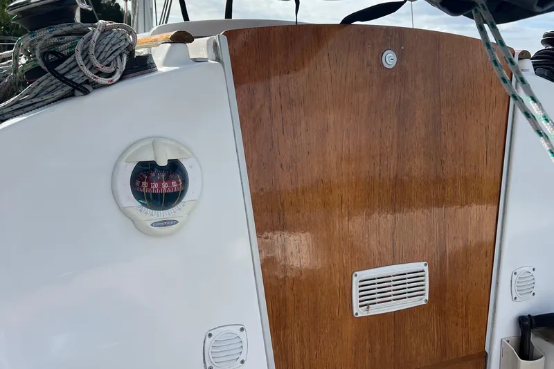 Slide: The Image of Beneteau FIRST 25 S 2014 sailboat cockpit with wooden hatch and nautical equipment. - 9