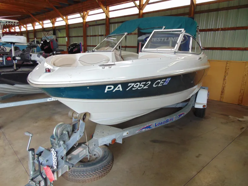 The Image of 1999 Maxum 1800 XR boat on trailer in storage facility. - 1