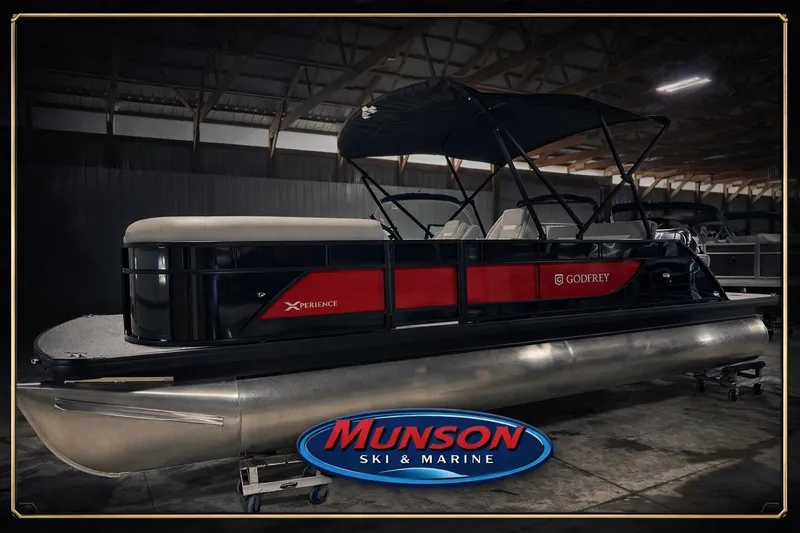 The Image of 2025 Godfrey EX 2286 SFLX pontoon boat in showroom, Munson Ski & Marine logo. - 0