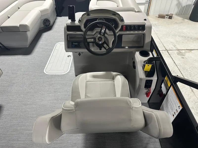 Slide: The Image of 2025 Godfrey Xperience Lounge boat interior with steering console and seating. - 14