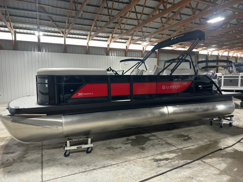 Slide: The Image of 2025 Godfrey Xperience Lounge pontoon boat in a warehouse setting. - 3