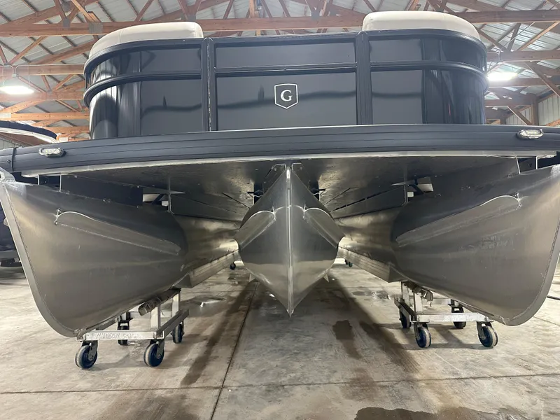 Slide: The Image of 2025 Godfrey Xperience Lounge pontoon boat in a warehouse, showcasing its sleek design. - 4