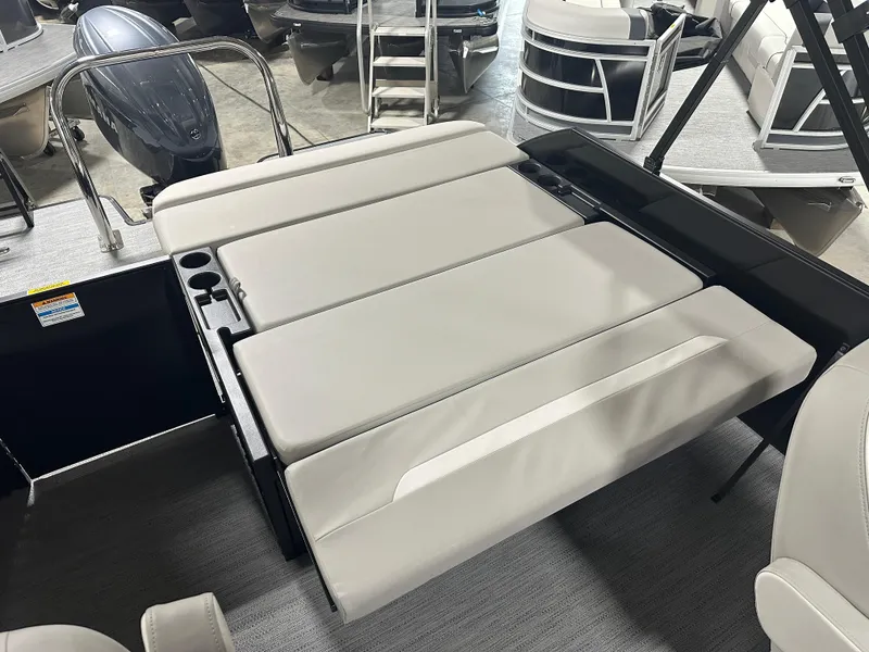 Slide: The Image of 2025 Godfrey Xperience Lounge boat interior with beige seating and cup holders. - 8