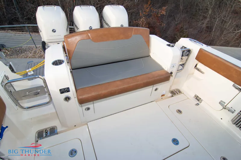 Slide: The Image of 2022 Scout 350 LXZ boat seating area with brown and gray upholstery. - 18