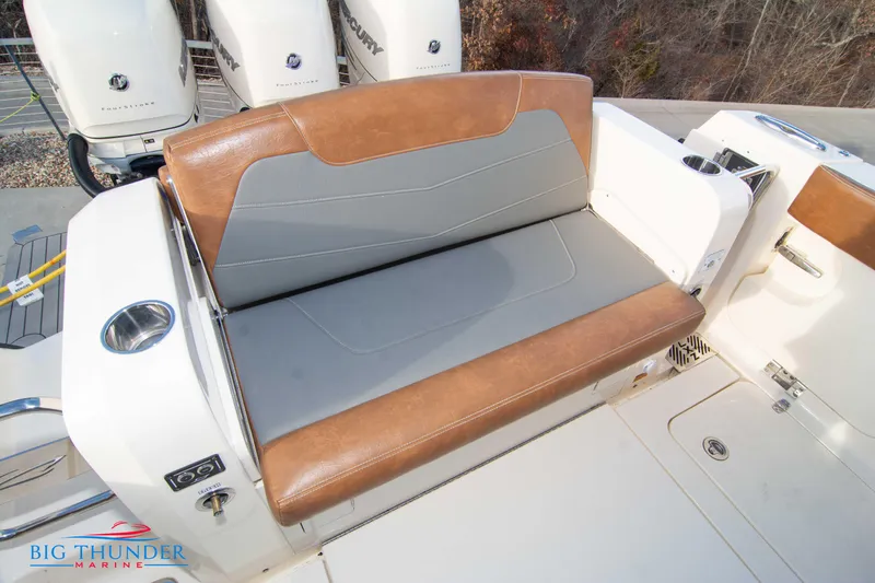 Slide: The Image of 2022 Scout 350 LXZ boat with brown and gray seating, featuring Mercury engines. - 19