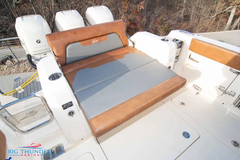 Slide: The Image of 2022 Scout 350 LXZ boat with luxurious seating and triple outboard engines. - 20