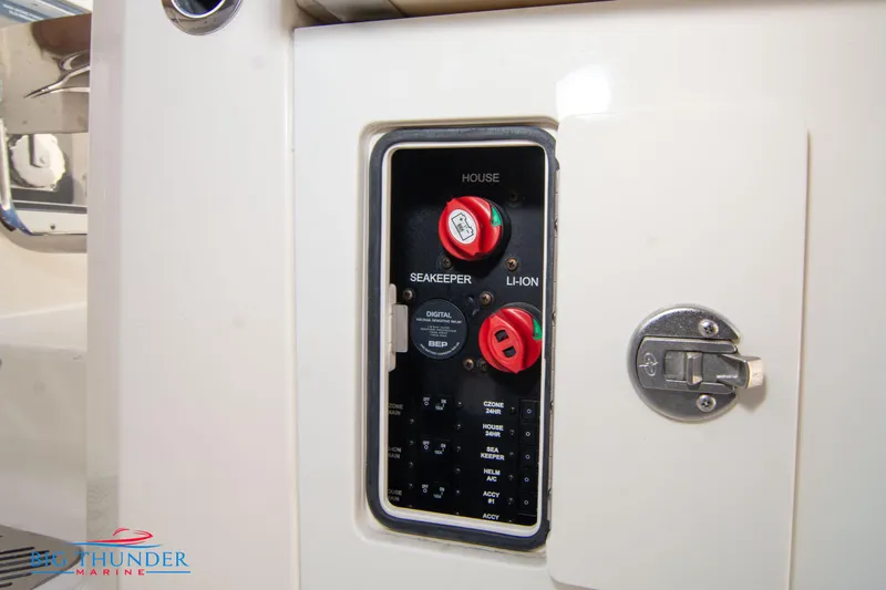 Slide: The Image of Control panel on a 2022 Scout 350 LXZ boat, featuring switches and dials. - 25
