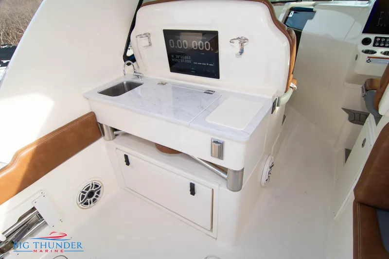 Slide: The Image of 2022 Scout 350 LXZ boat interior with sink and control panel. - 28