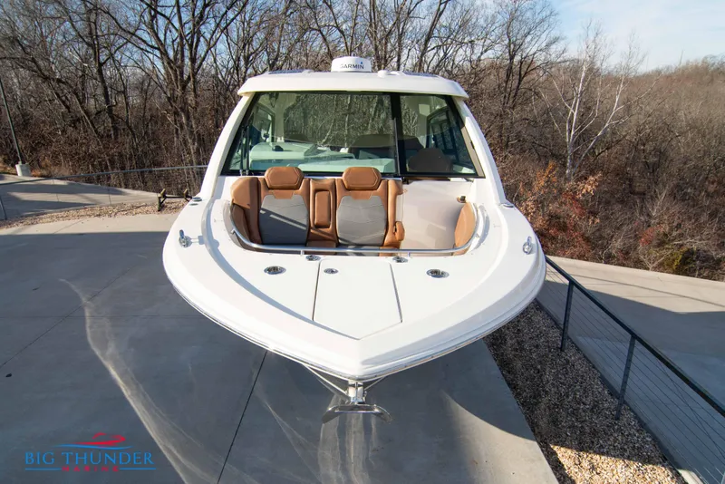 Slide: The Image of 2022 Scout 350 LXZ boat with sleek design, parked outdoors on a sunny day. - 3