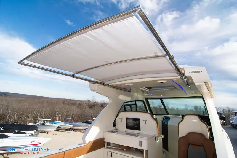 Slide: The Image of 2022 Scout 350 LXZ boat with open canopy and modern interior design. - 37