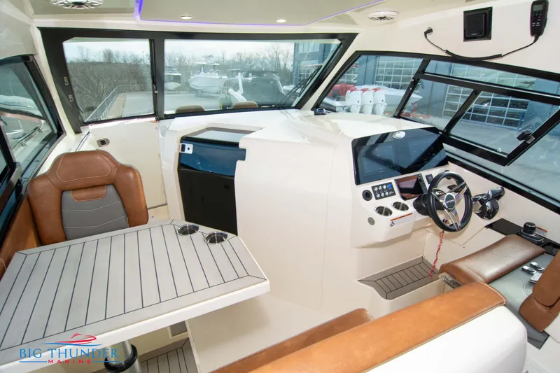 Slide: The Image of 2022 Scout 350 LXZ boat interior with modern helm, seating, and table. - 42