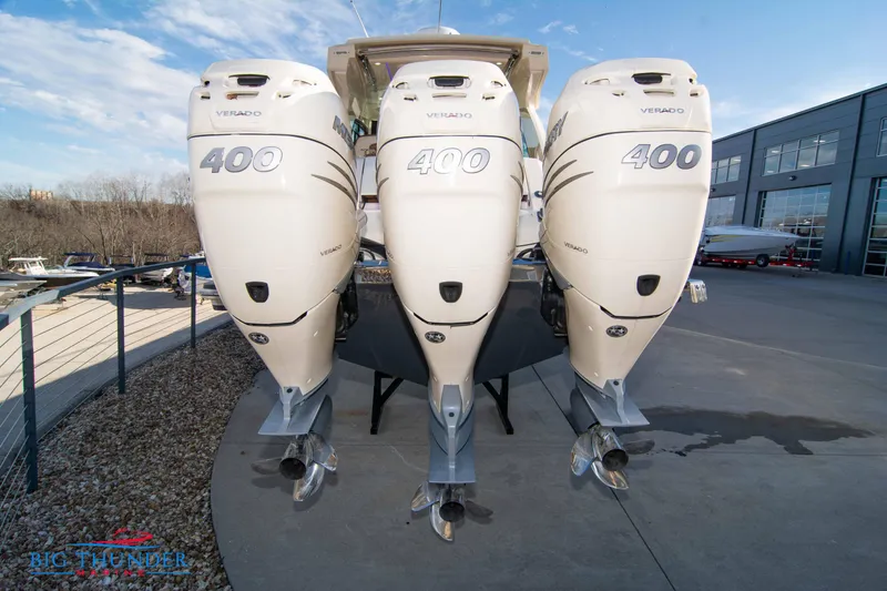 Slide: The Image of 2022 Scout 350 LXZ with triple 400 horsepower outboard engines, docked outdoors. - 6