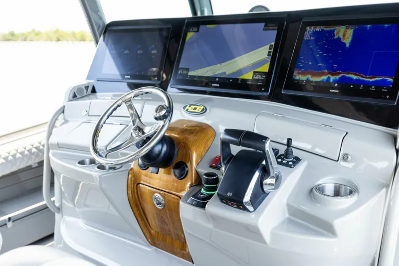 Slide: The Image of Helm of 2023 HCB 53 Sueños boat with advanced navigation displays and controls. - 10