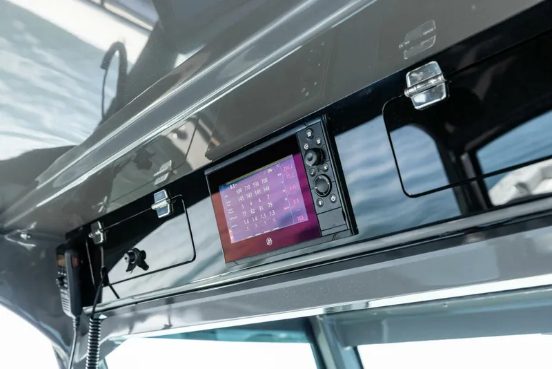 Slide: The Image of 2023 HCB 53 Sueños boat dashboard with electronic display and control panel. - 13