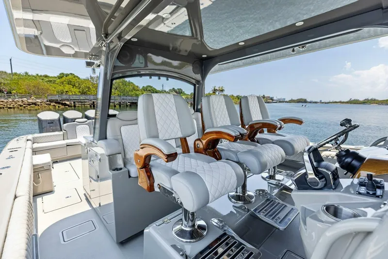 Slide: The Image of Luxury interior of 2023 HCB 53 Sueños boat with plush seating and modern controls. - 14