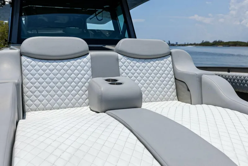 Slide: The Image of Luxurious seating on 2023 HCB 53 Sueños boat with quilted upholstery and cup holder. - 21